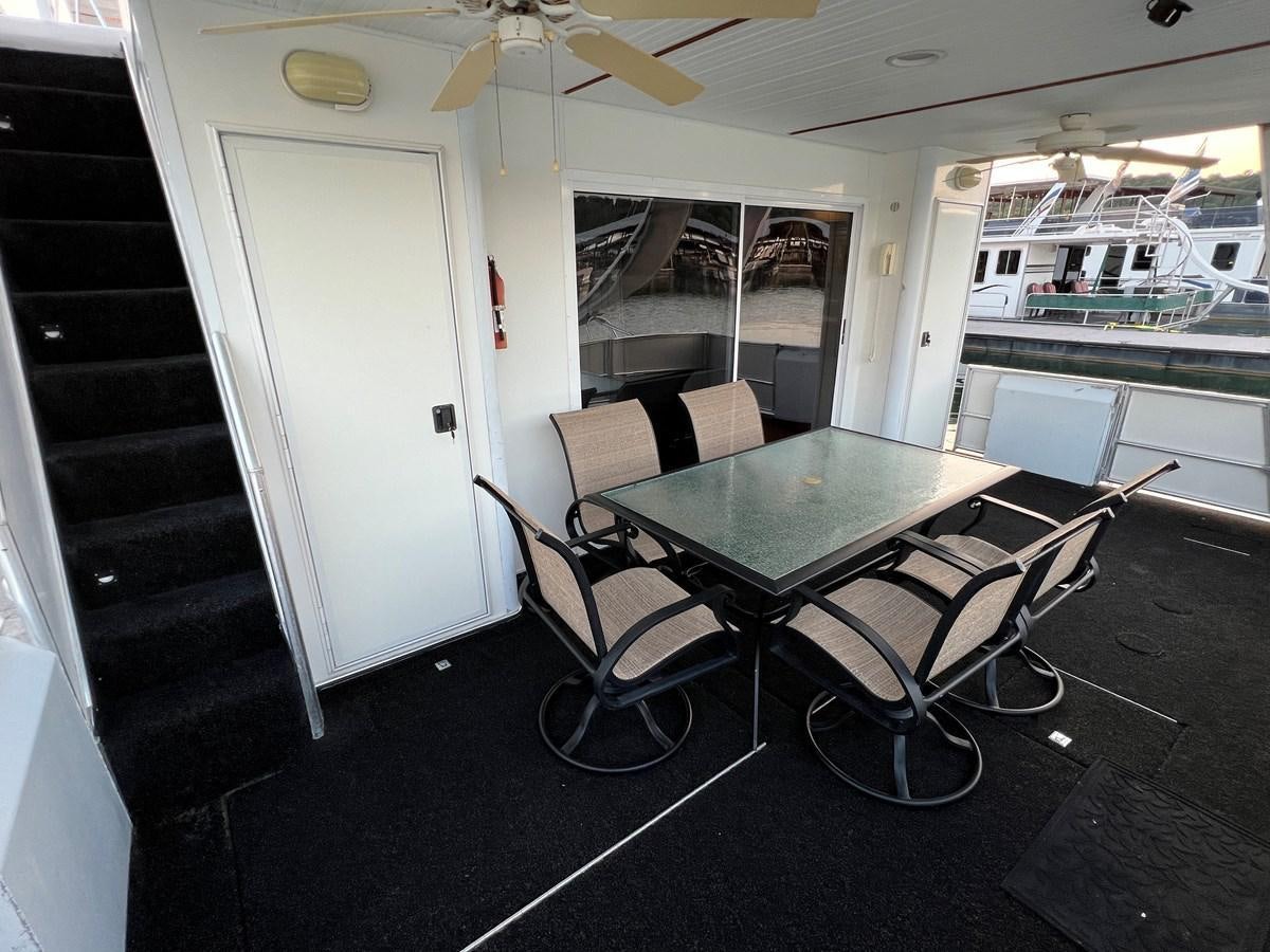 a table and chairs in a room aboard 2007 STARDUST 19 X 86WB NLCG Yacht for Sale