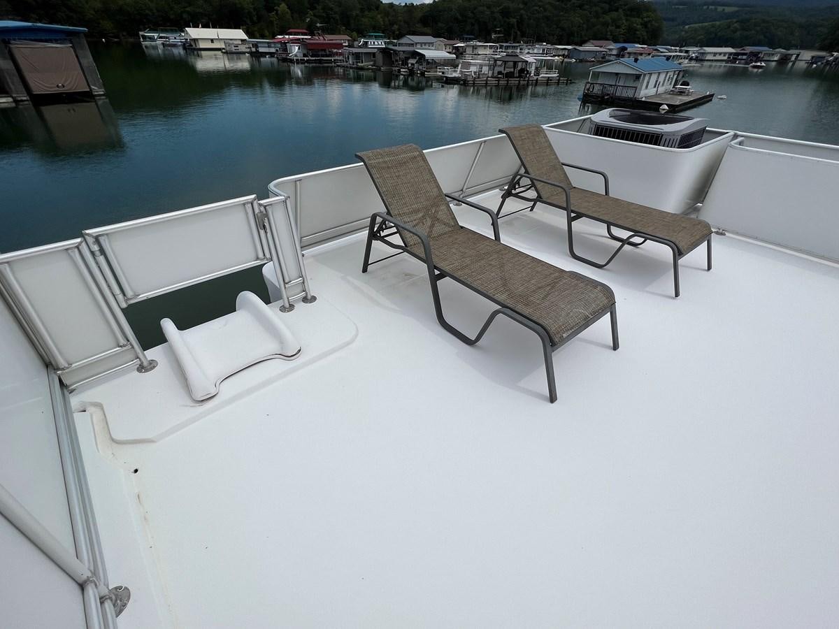 a group of benches on a white surface next to a body of water aboard 2007 STARDUST 19 X 86WB NLCG Yacht for Sale