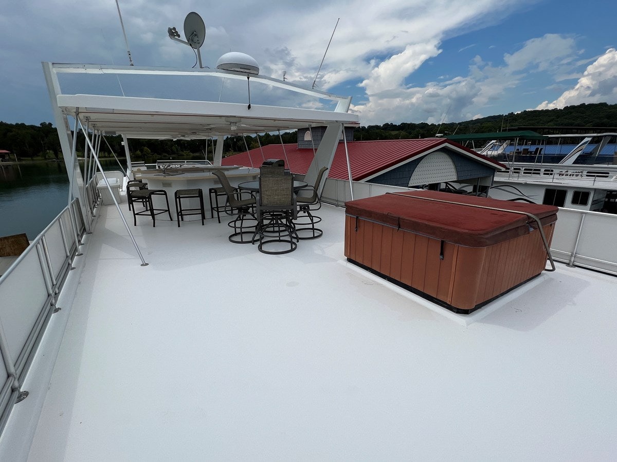 a deck with chairs and tables on it aboard 2007 STARDUST 19 X 86WB NLCG Yacht for Sale