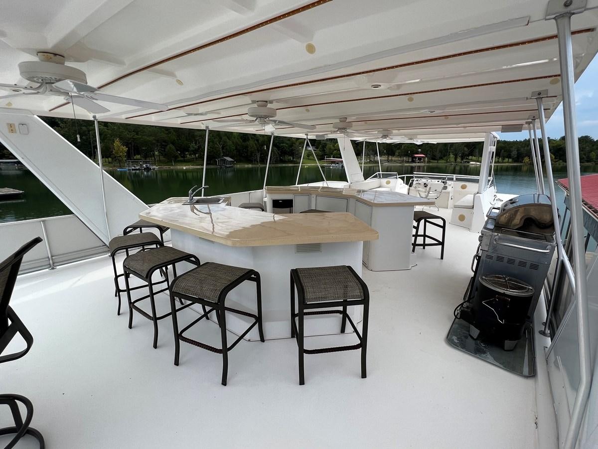 a room with tables and chairs aboard 2007 STARDUST 19 X 86WB NLCG Yacht for Sale