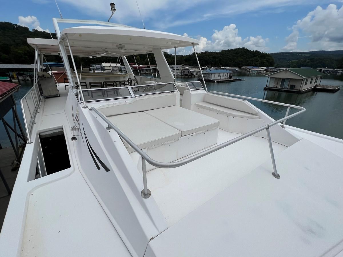 a white boat in a harbor aboard 2007 STARDUST 19 X 86WB NLCG Yacht for Sale