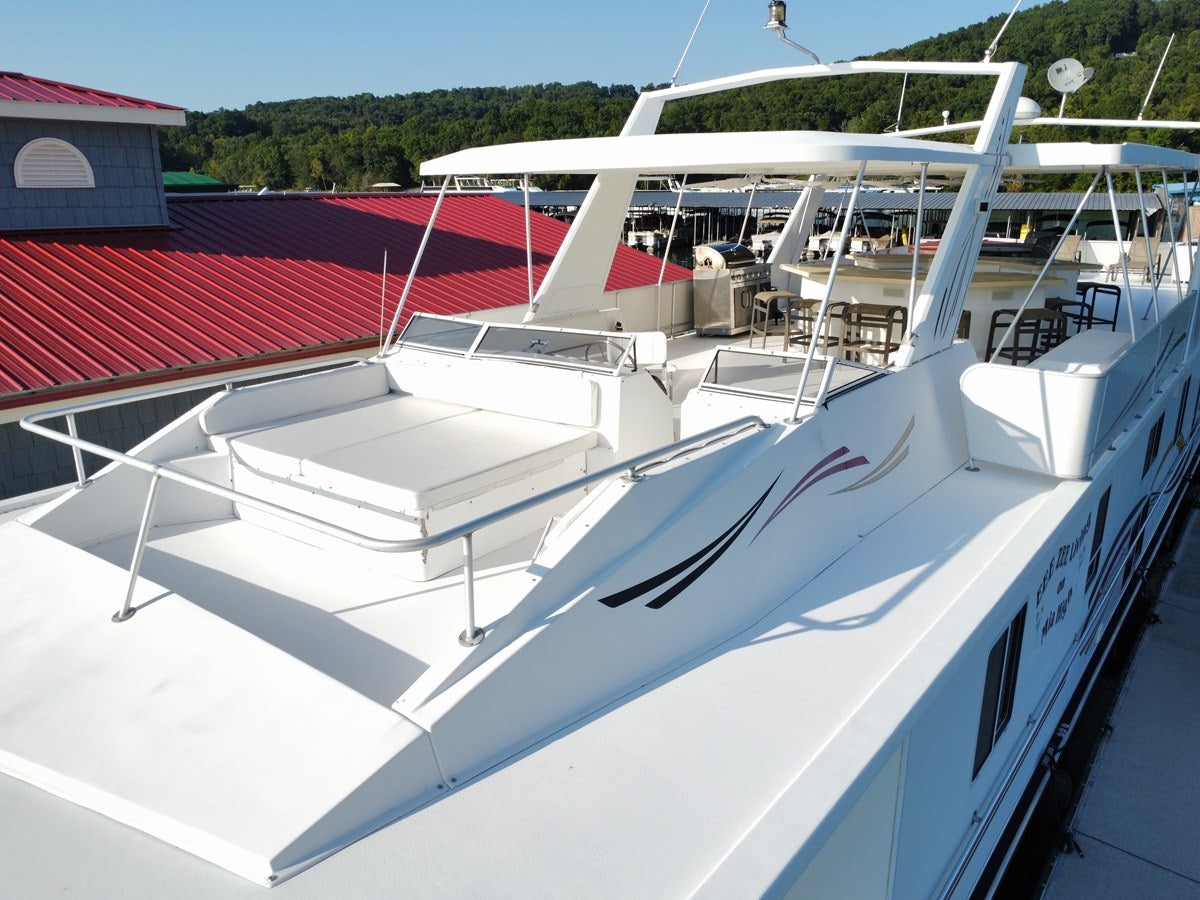 a white boat with a red roof aboard 2007 STARDUST 19 X 86WB NLCG Yacht for Sale
