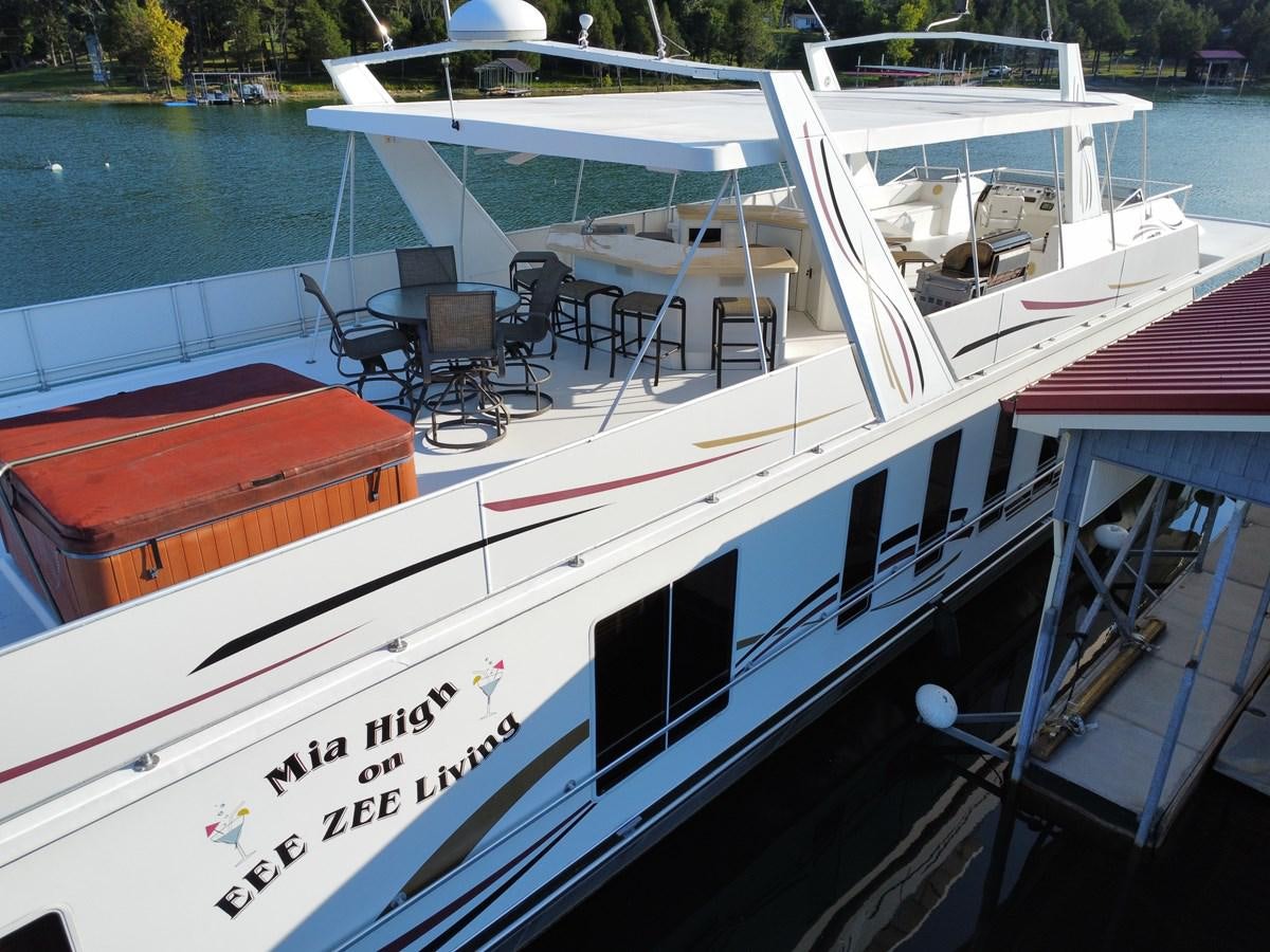 a boat with a table and chairs on the deck aboard 2007 STARDUST 19 X 86WB NLCG Yacht for Sale