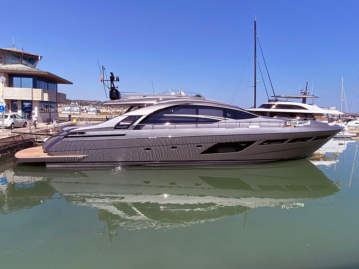 a white yacht docked at a dock aboard CUCU Yacht for Sale