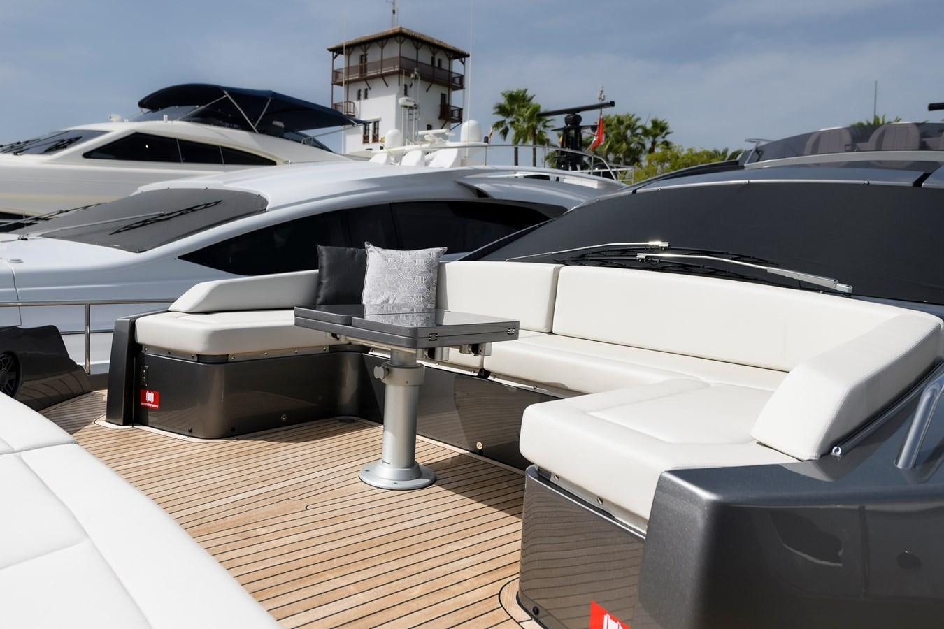 a white car with a table and chairs on a deck aboard CUCU Yacht for Sale