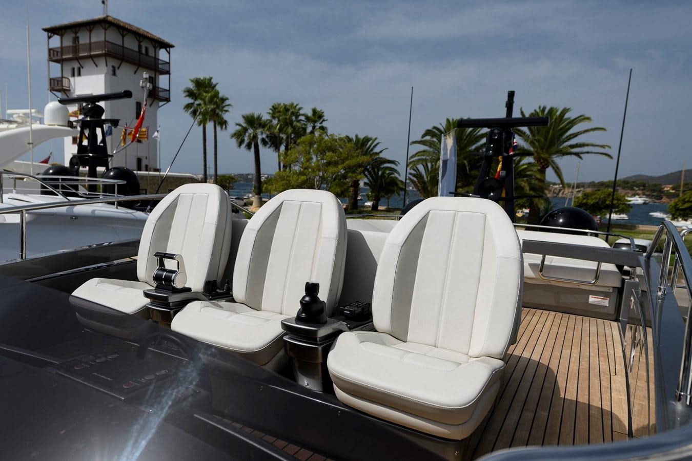 a deck with chairs and umbrellas aboard CUCU Yacht for Sale