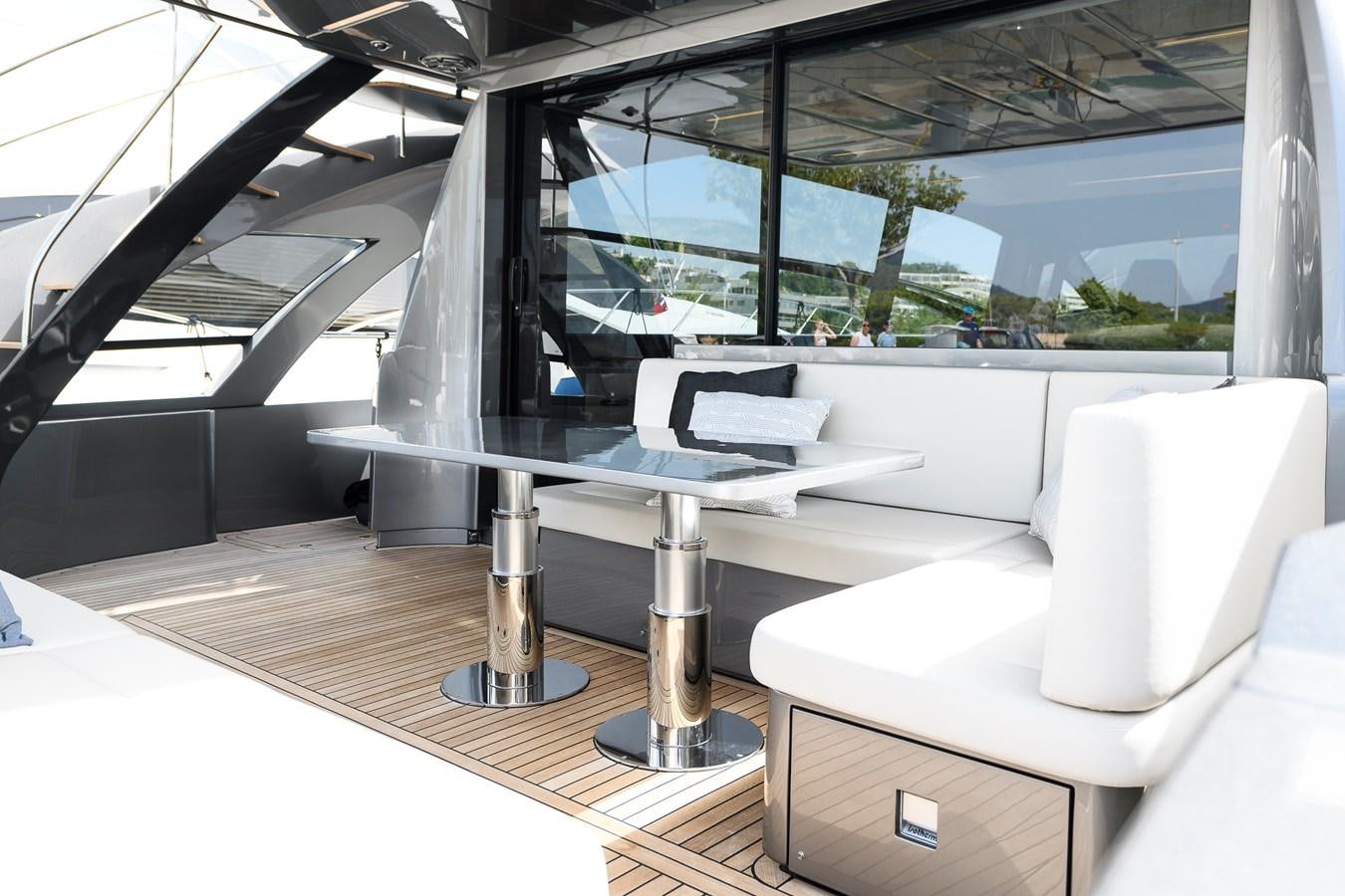 a room with a table and chairs aboard CUCU Yacht for Sale