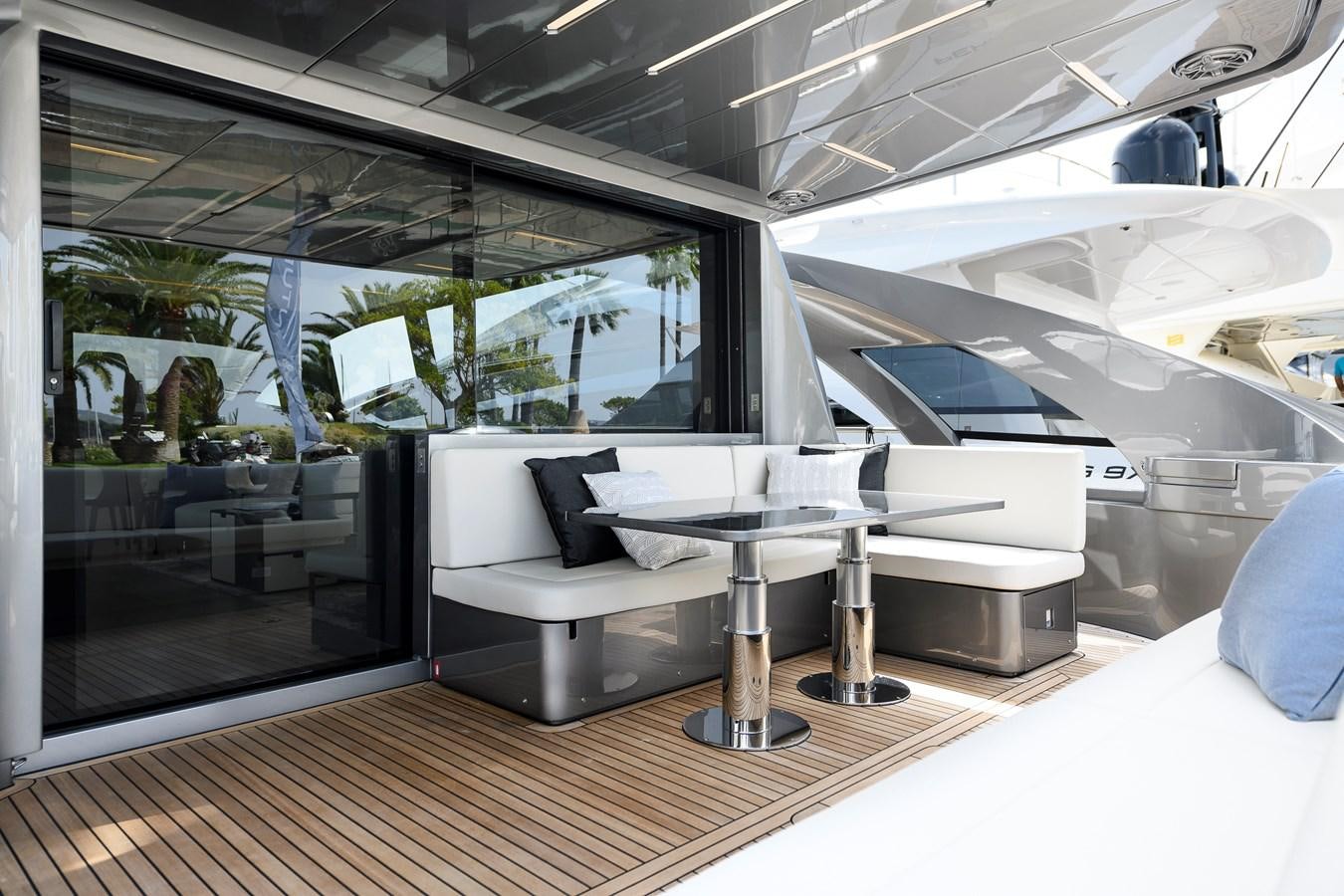 a room with a table and couches aboard CUCU Yacht for Sale