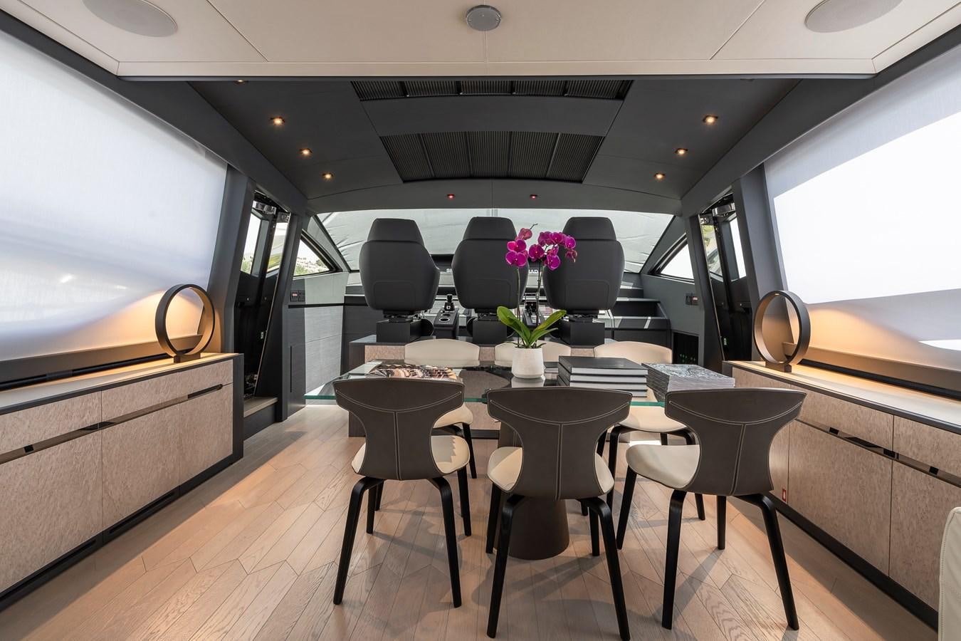 a room with a table and chairs aboard CUCU Yacht for Sale