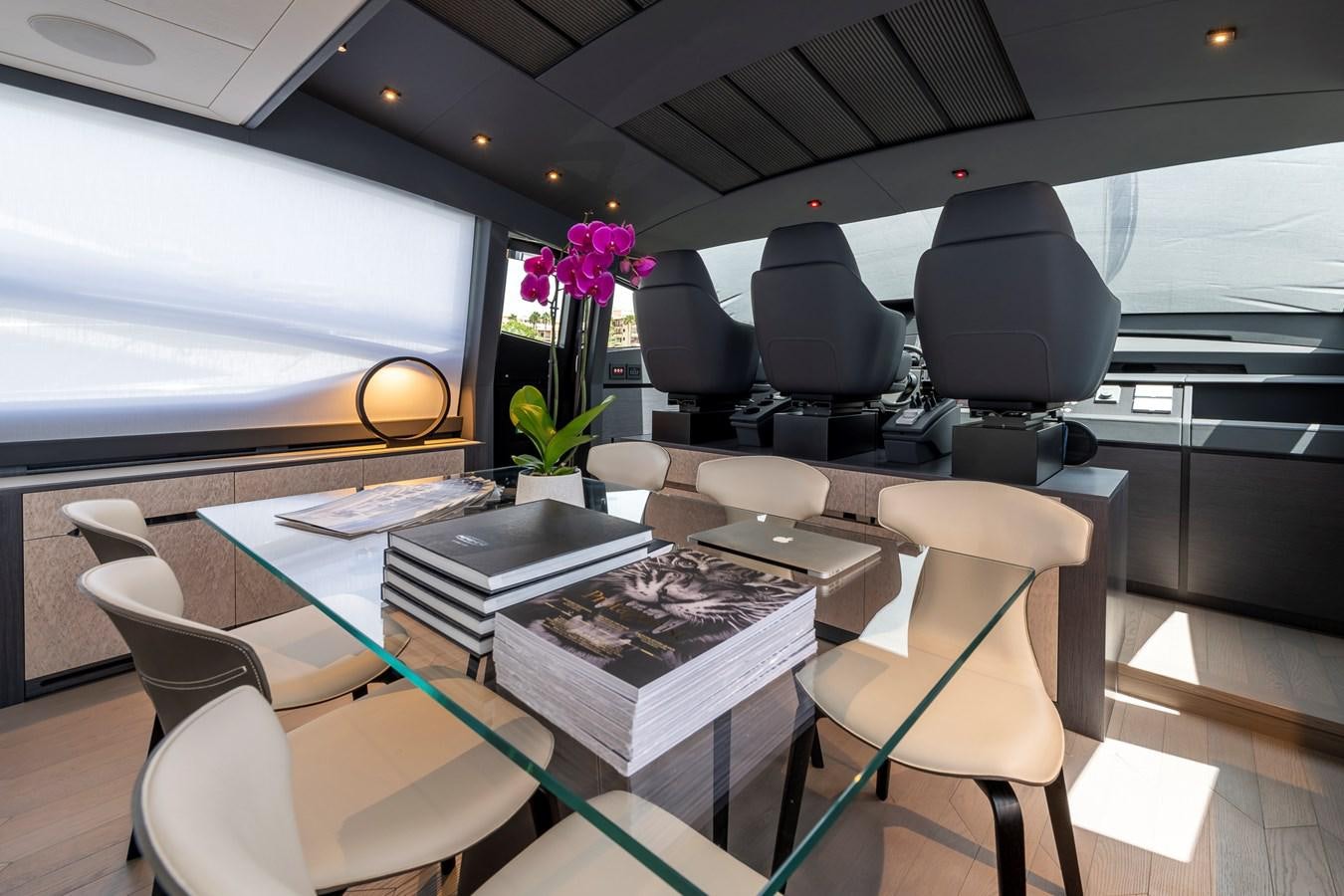 a room with chairs and a table aboard CUCU Yacht for Sale