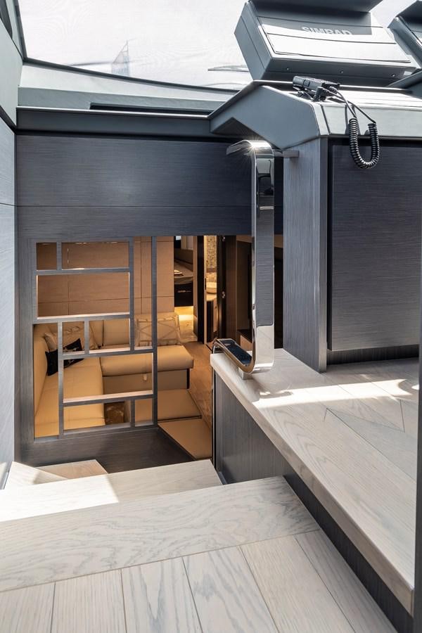 a room with a wood floor and a shelf with a computer on it aboard CUCU Yacht for Sale