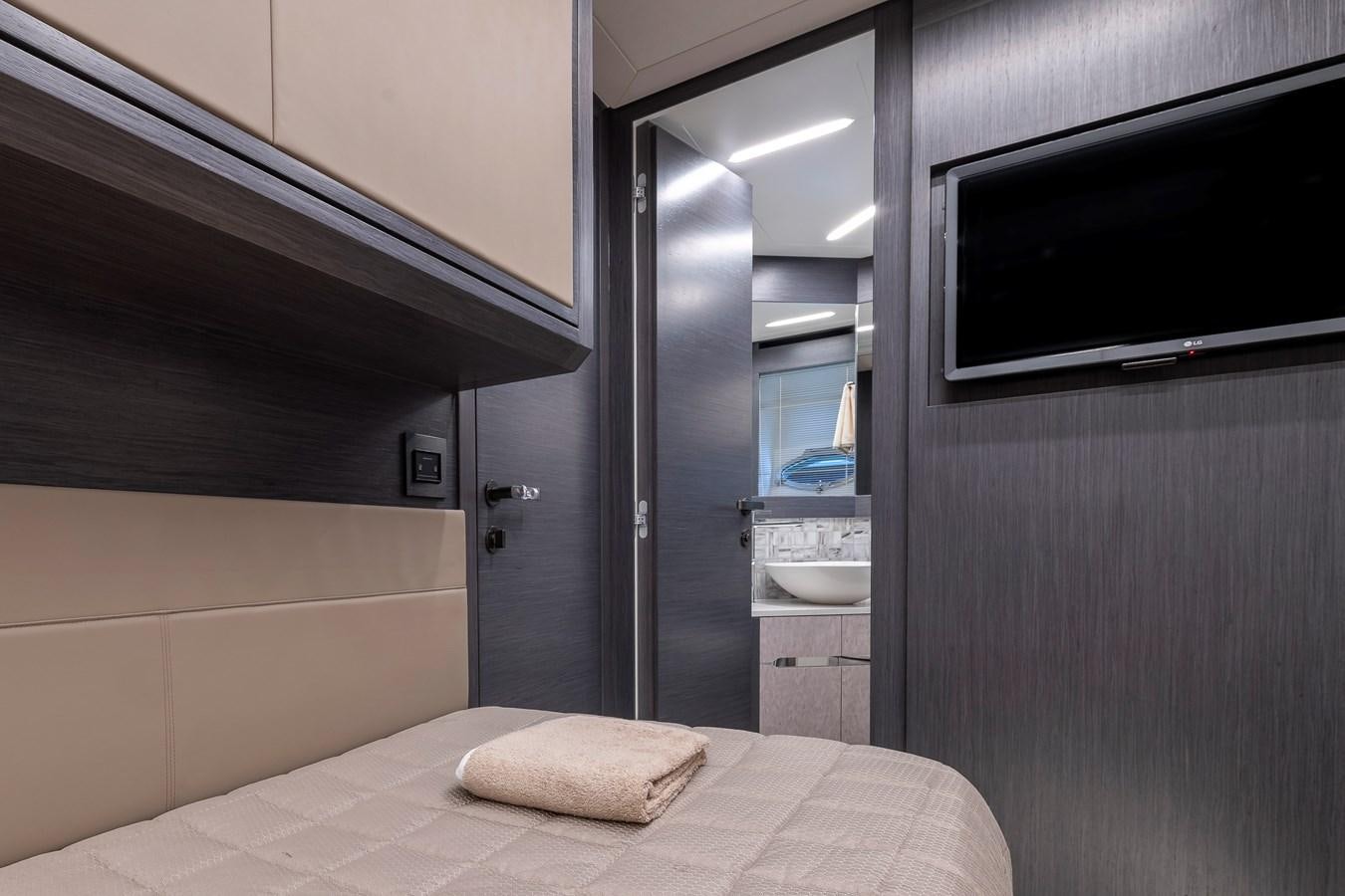 a bedroom with a bed and a microwave aboard CUCU Yacht for Sale