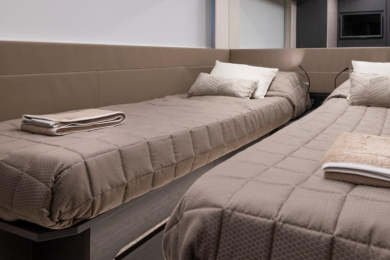 a bed with a brown comforter aboard CUCU Yacht for Sale