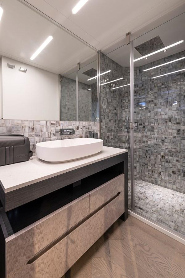 a bathroom with a glass shower aboard CUCU Yacht for Sale