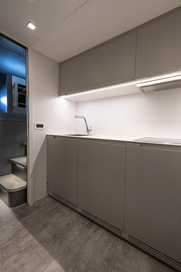 a kitchen with a sink and a window aboard CUCU Yacht for Sale