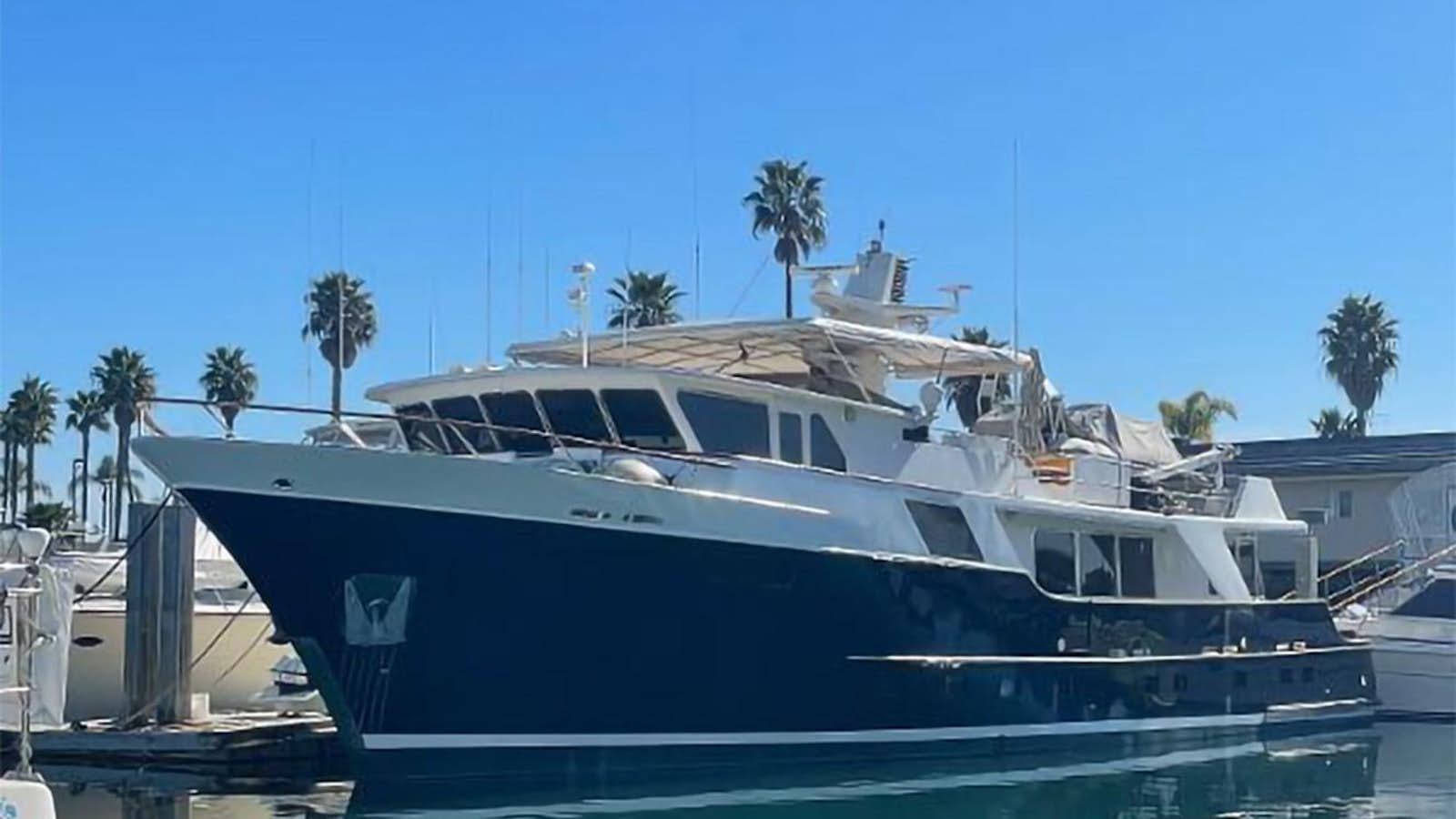 a large white yacht docked aboard KAMAHELE Yacht for Sale