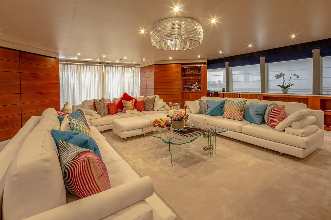 a living room with a couch and a table aboard LUCY III Yacht for Sale