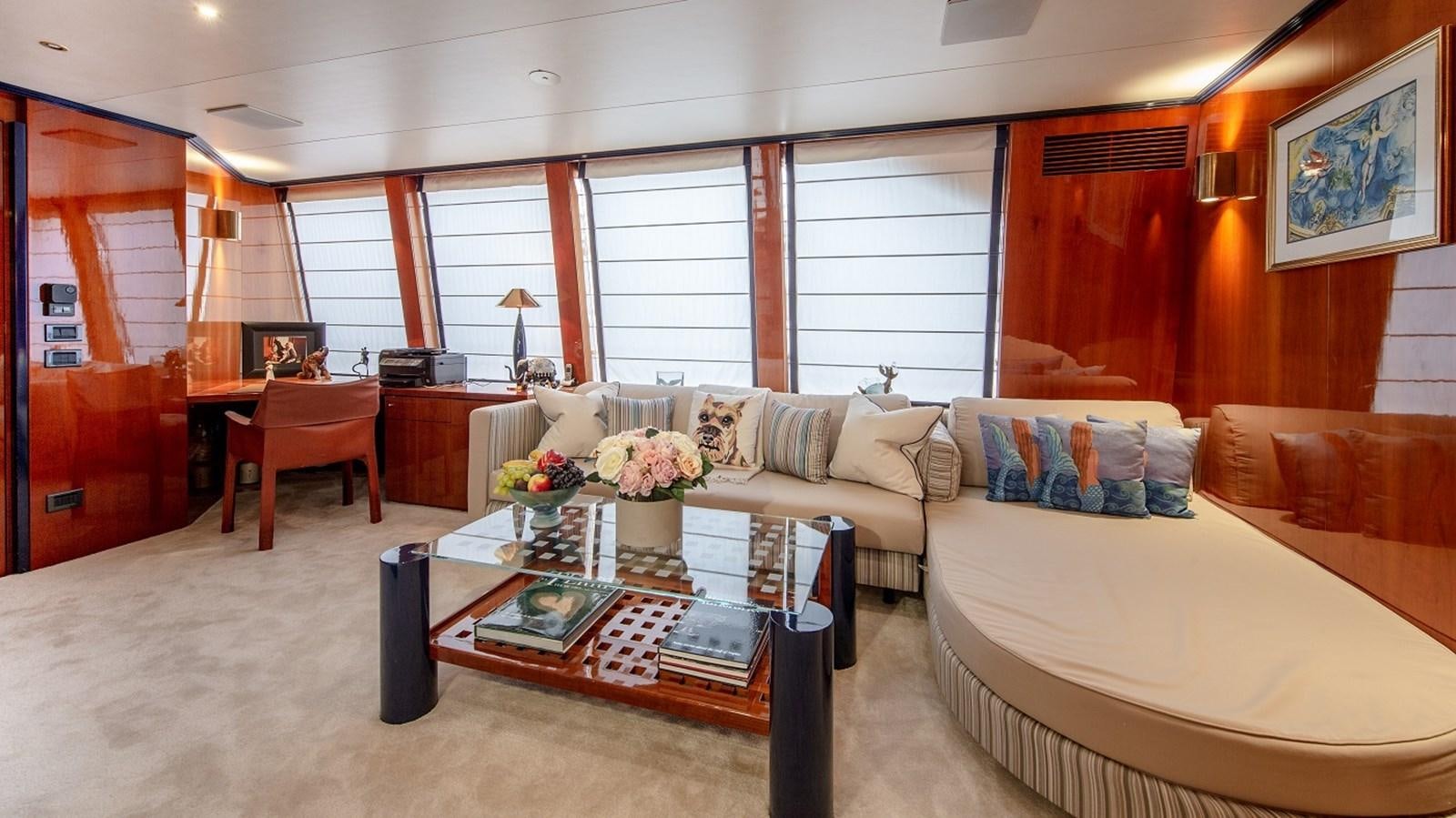 a living room with a couch and a coffee table aboard LUCY III Yacht for Sale