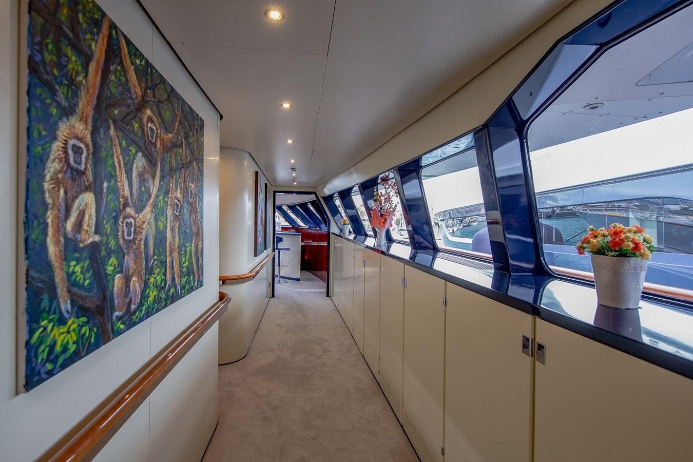 a hallway with a painting on the wall aboard LUCY III Yacht for Sale
