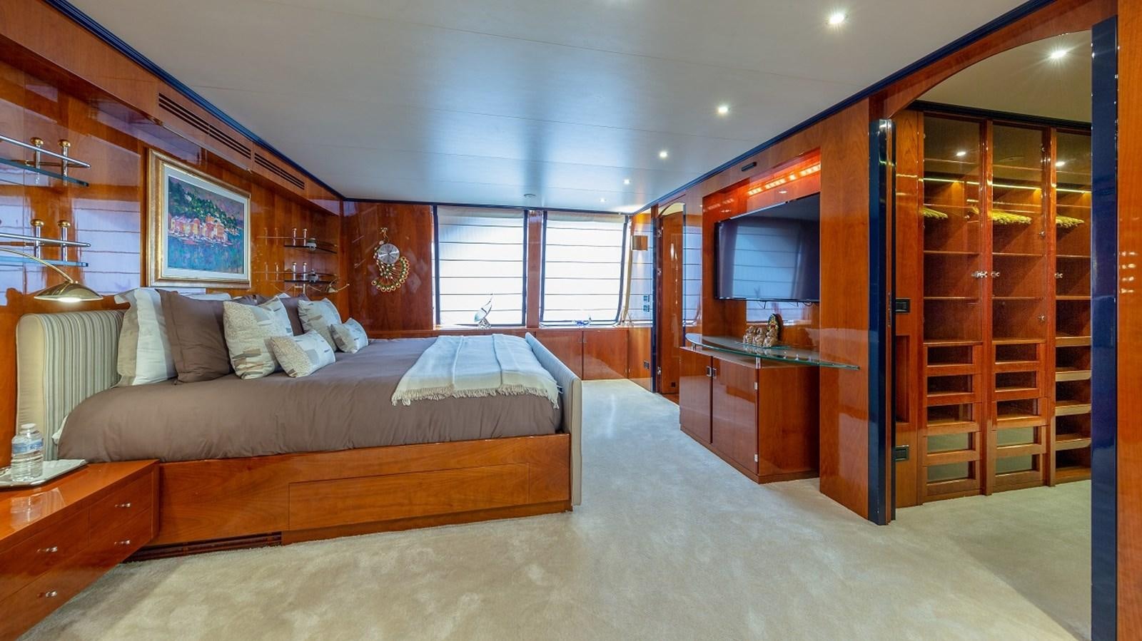 a bedroom with a bed and a closet aboard LUCY III Yacht for Sale