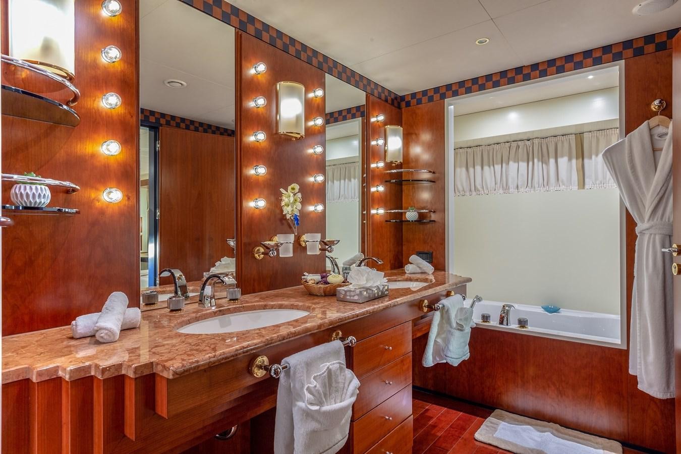 a bathroom with a large mirror aboard LUCY III Yacht for Sale