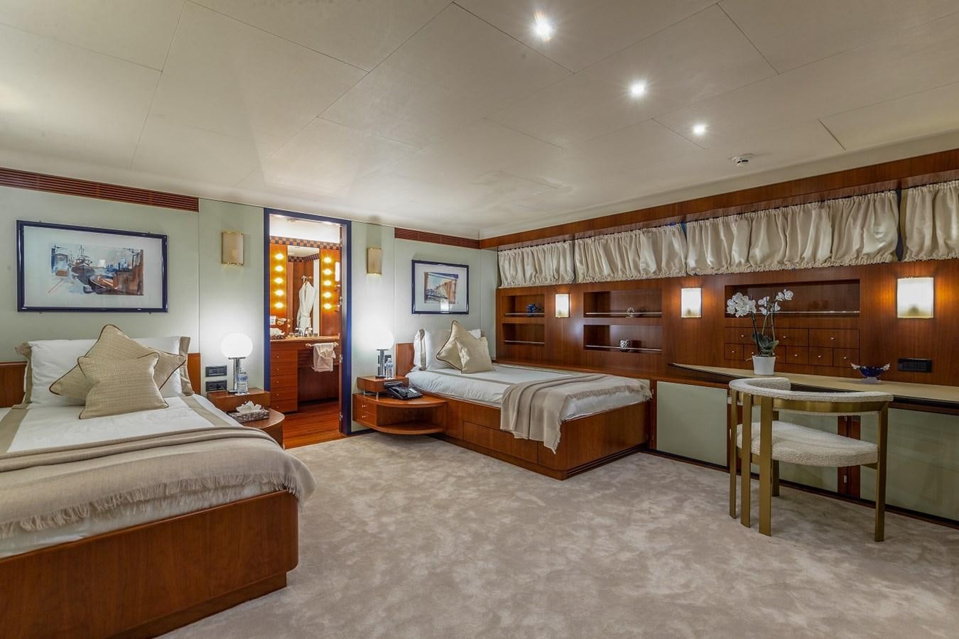 a room with a bed and a desk aboard LUCY III Yacht for Sale