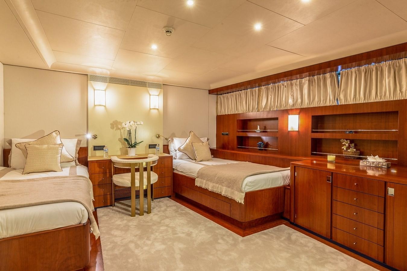 a room with a bed and a table aboard LUCY III Yacht for Sale