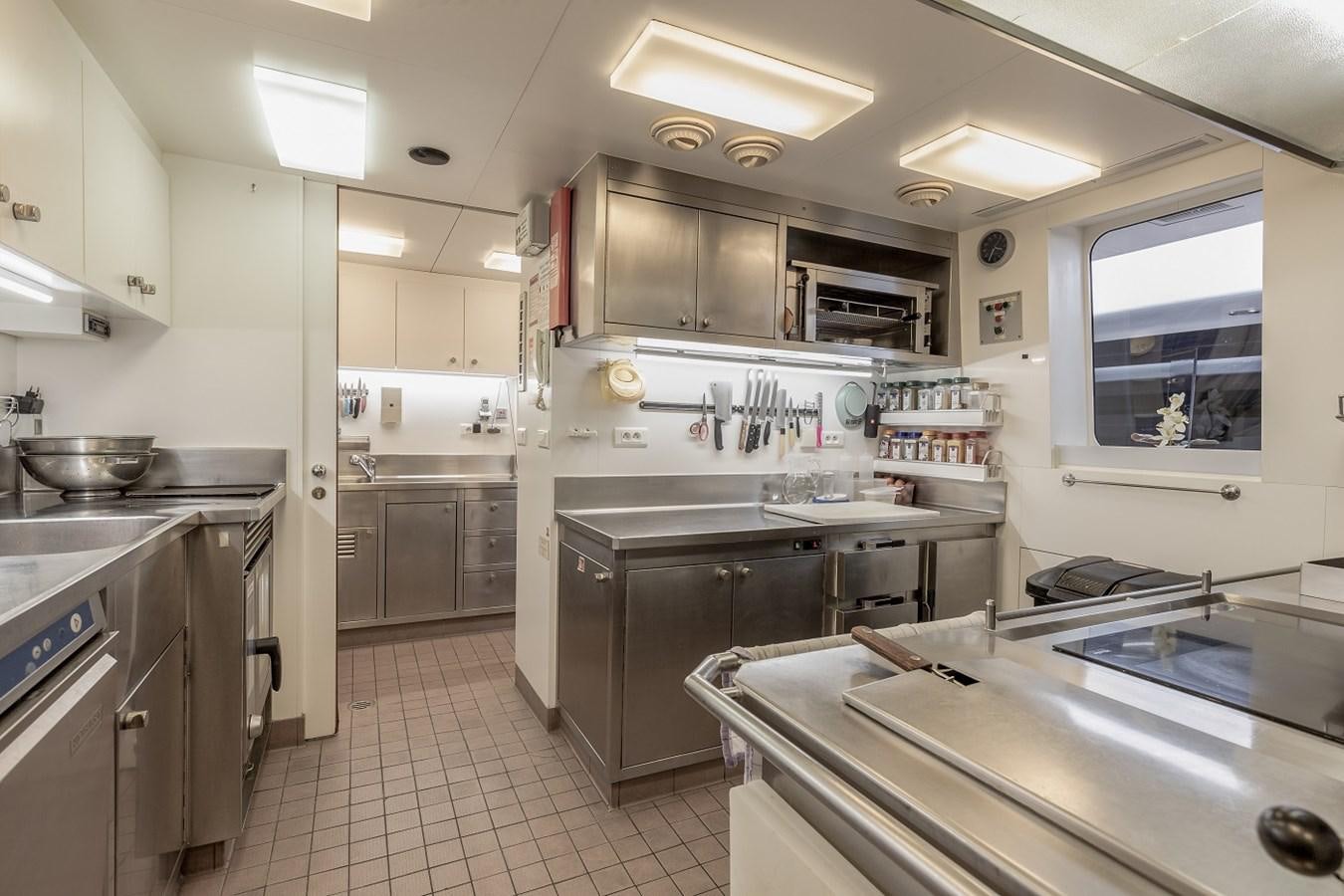 a kitchen with white cabinets aboard LUCY III Yacht for Sale
