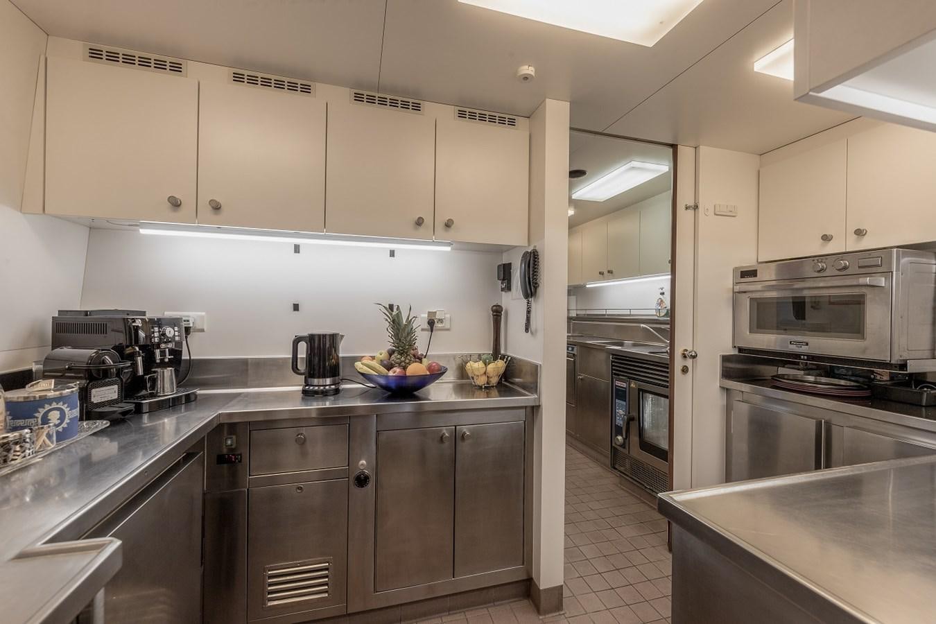 a kitchen with stainless steel appliances aboard LUCY III Yacht for Sale