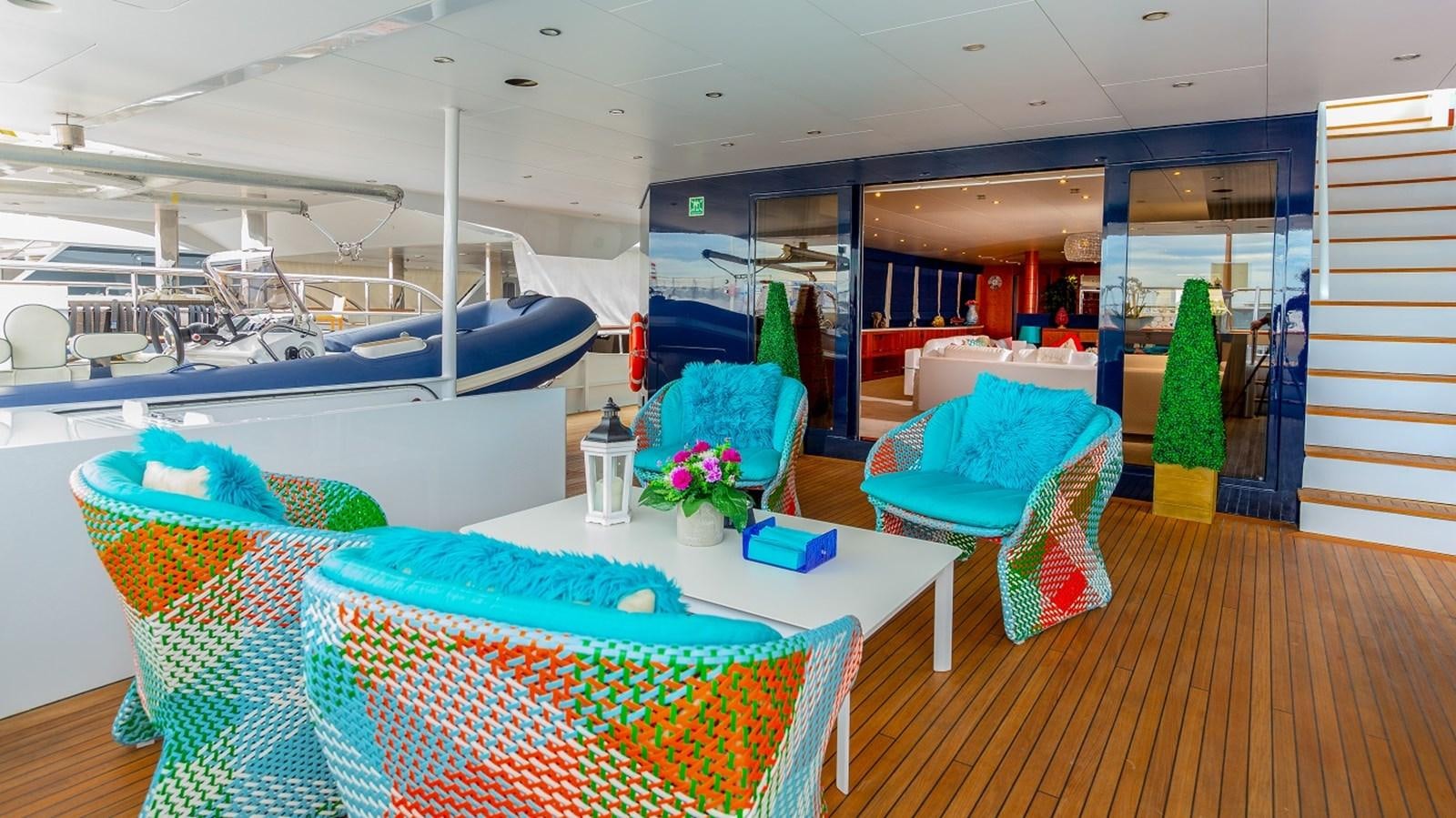 a room with a table chairs and a bed aboard LUCY III Yacht for Sale