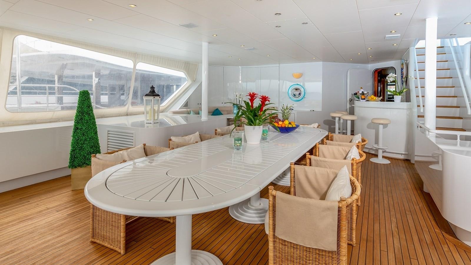 a large white table in a room aboard LUCY III Yacht for Sale