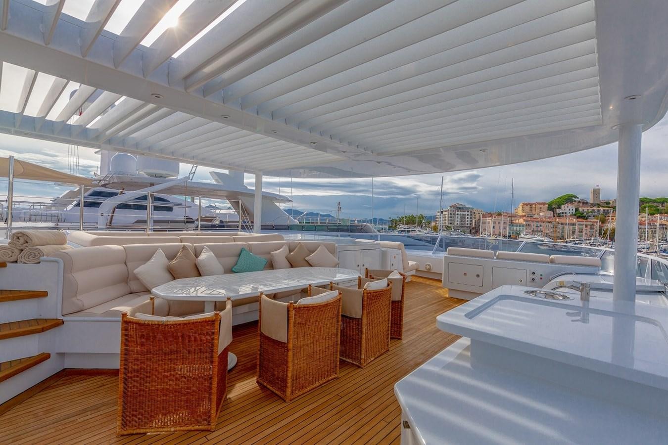a large living room with a view of the city aboard LUCY III Yacht for Sale