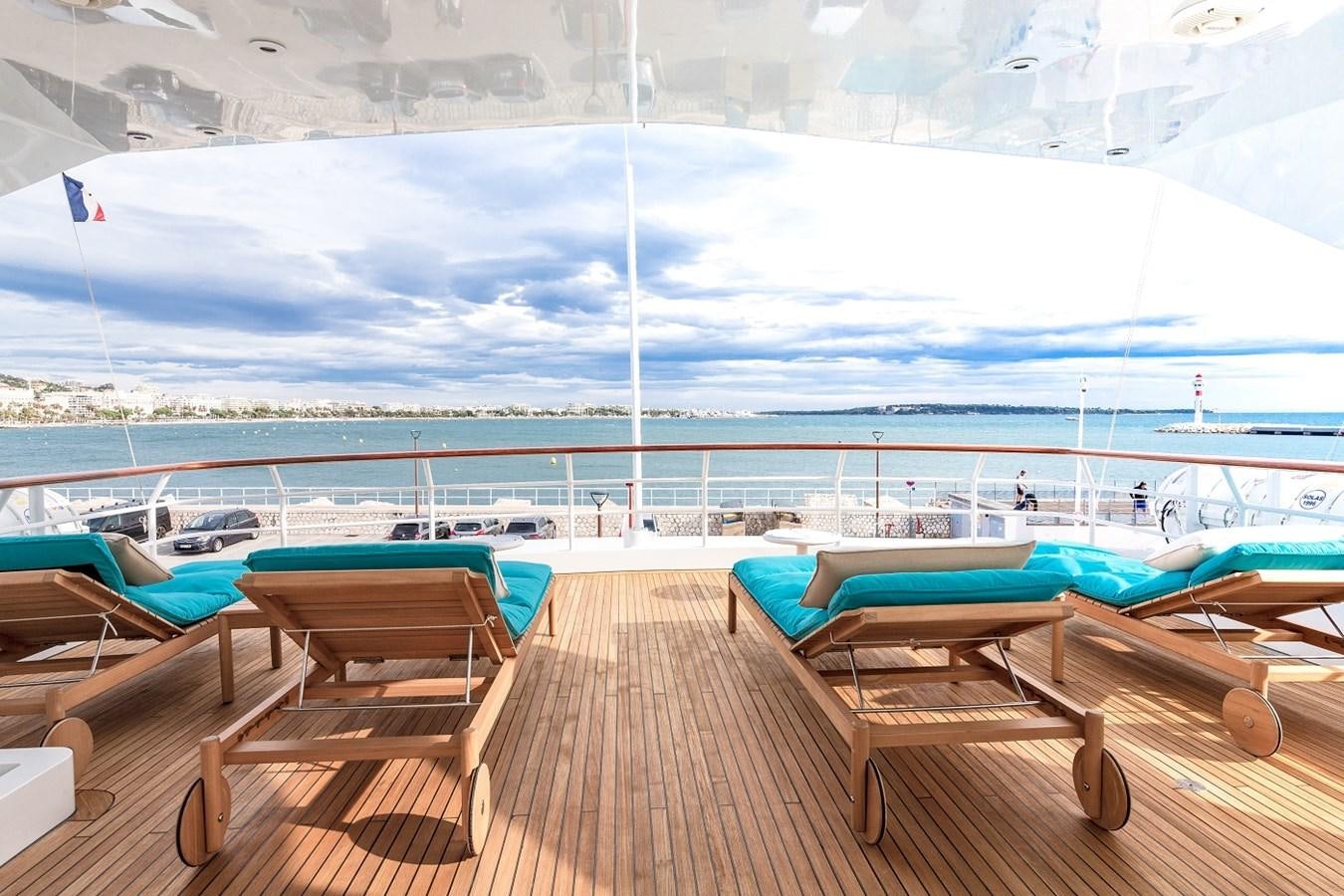 a deck with chairs and a pool aboard LUCY III Yacht for Sale