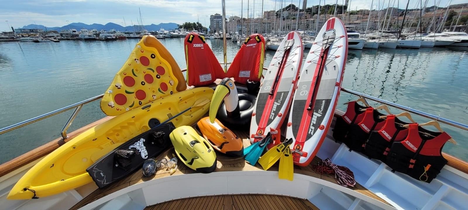 a yellow and red kayak on a boat aboard LUCY III Yacht for Sale