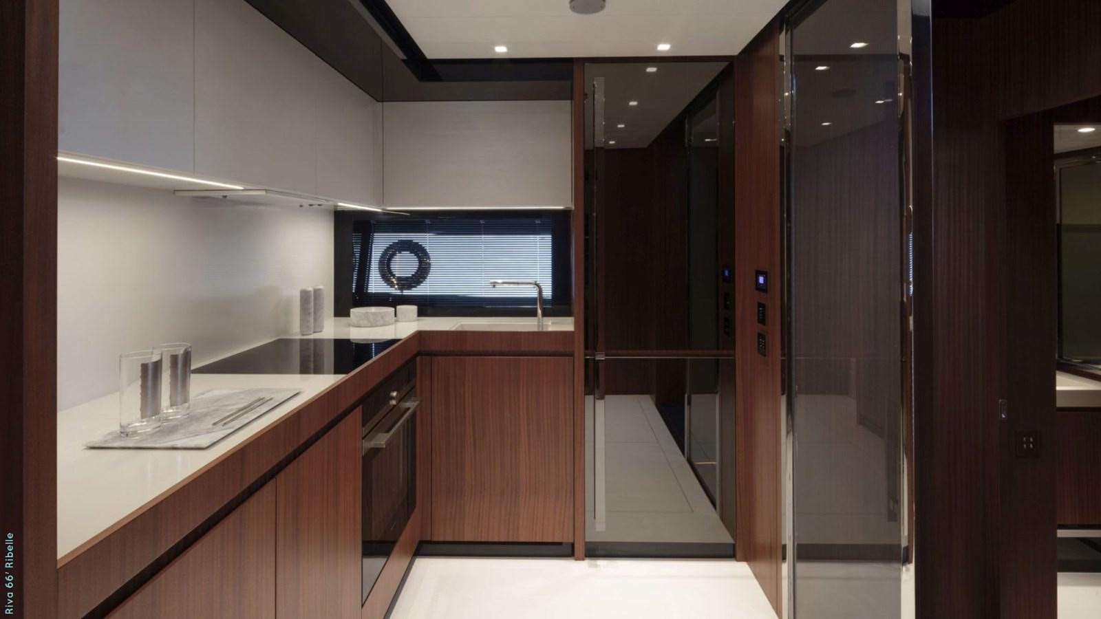 a kitchen with a large tv aboard N1 Yacht for Sale