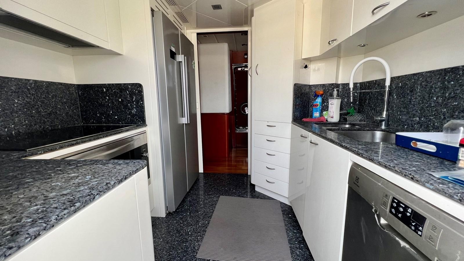 a kitchen with a black counter top aboard AZUR LE ROI Yacht for Sale