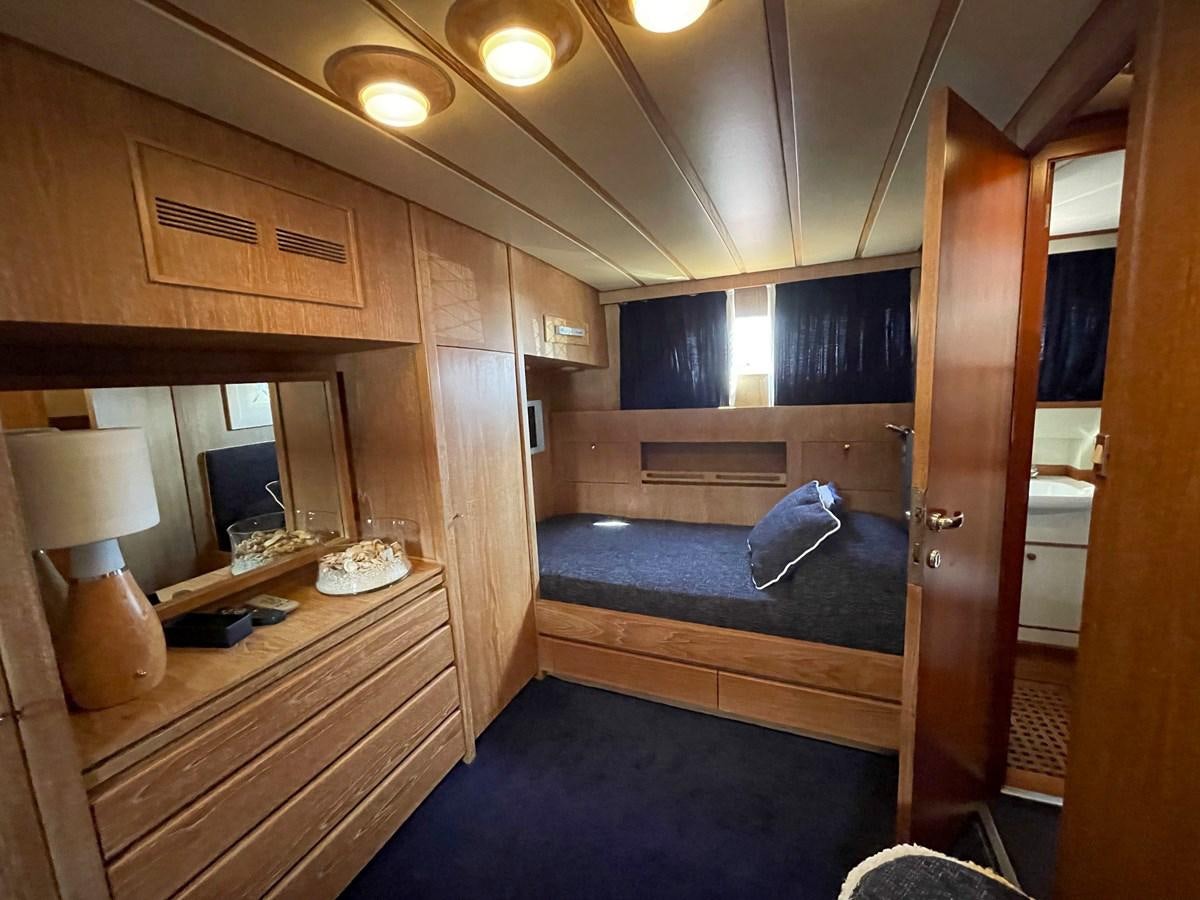 a room with a bed and a desk aboard QUADRIFOGLIO Yacht for Sale