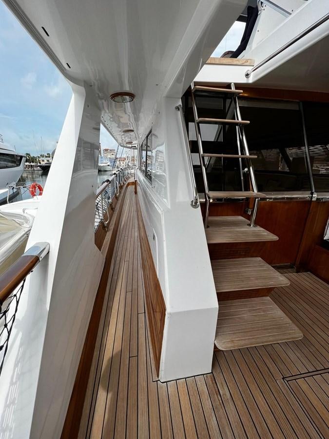 a white boat on a deck aboard QUADRIFOGLIO Yacht for Sale