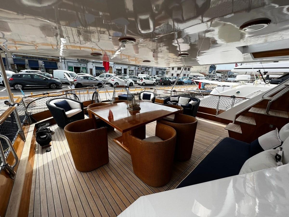 a room with a table and chairs aboard QUADRIFOGLIO Yacht for Sale