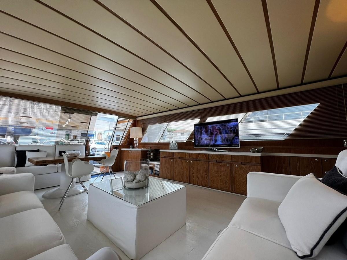 a room with a table and a tv aboard QUADRIFOGLIO Yacht for Sale