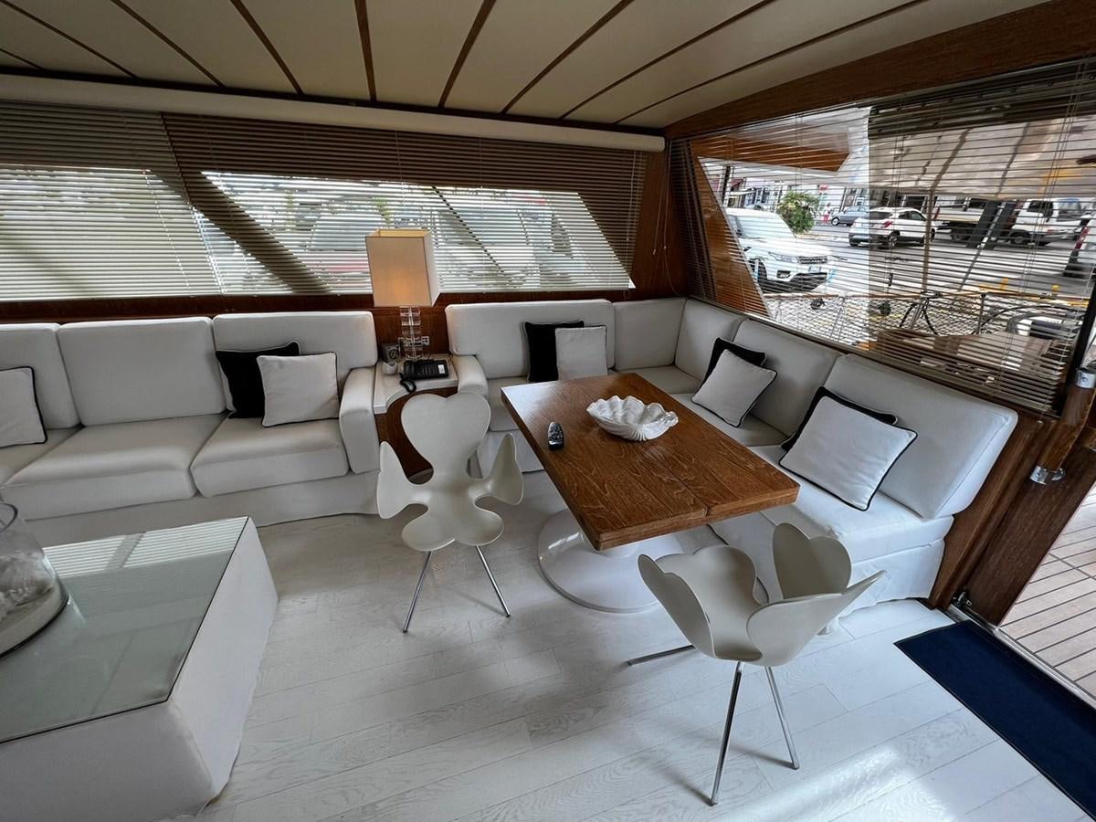 a living room with a table and chairs aboard QUADRIFOGLIO Yacht for Sale
