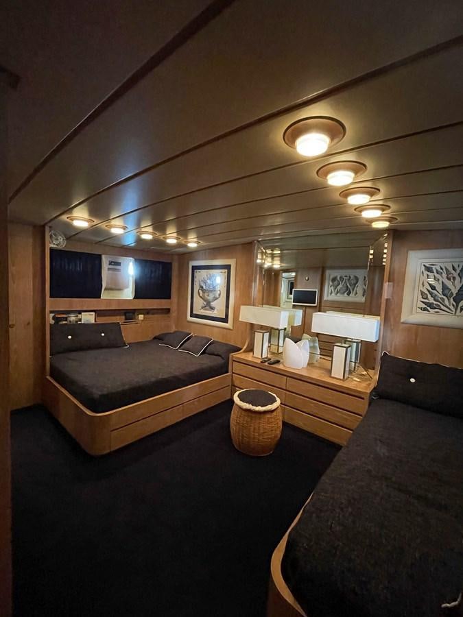 a room with a couch and a tv on the wall aboard QUADRIFOGLIO Yacht for Sale