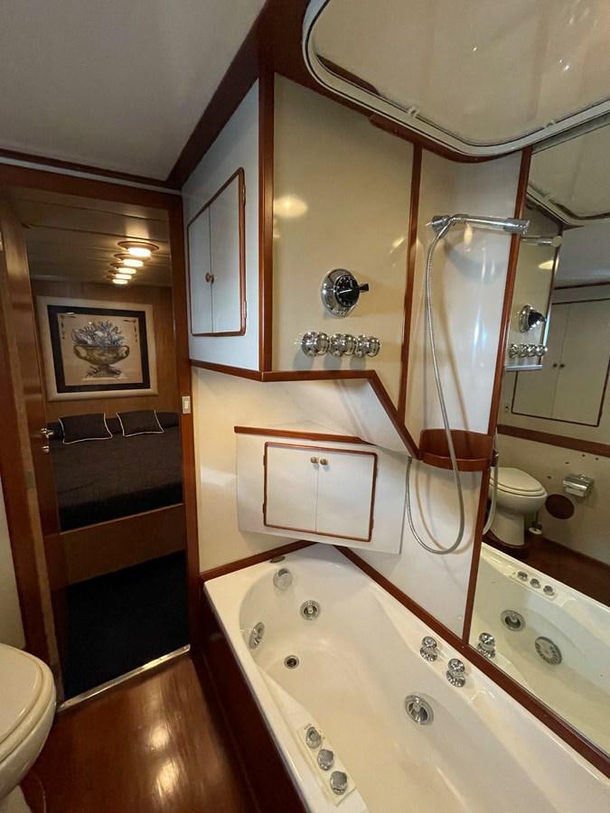 a bathroom with a tub sink and toilet aboard QUADRIFOGLIO Yacht for Sale