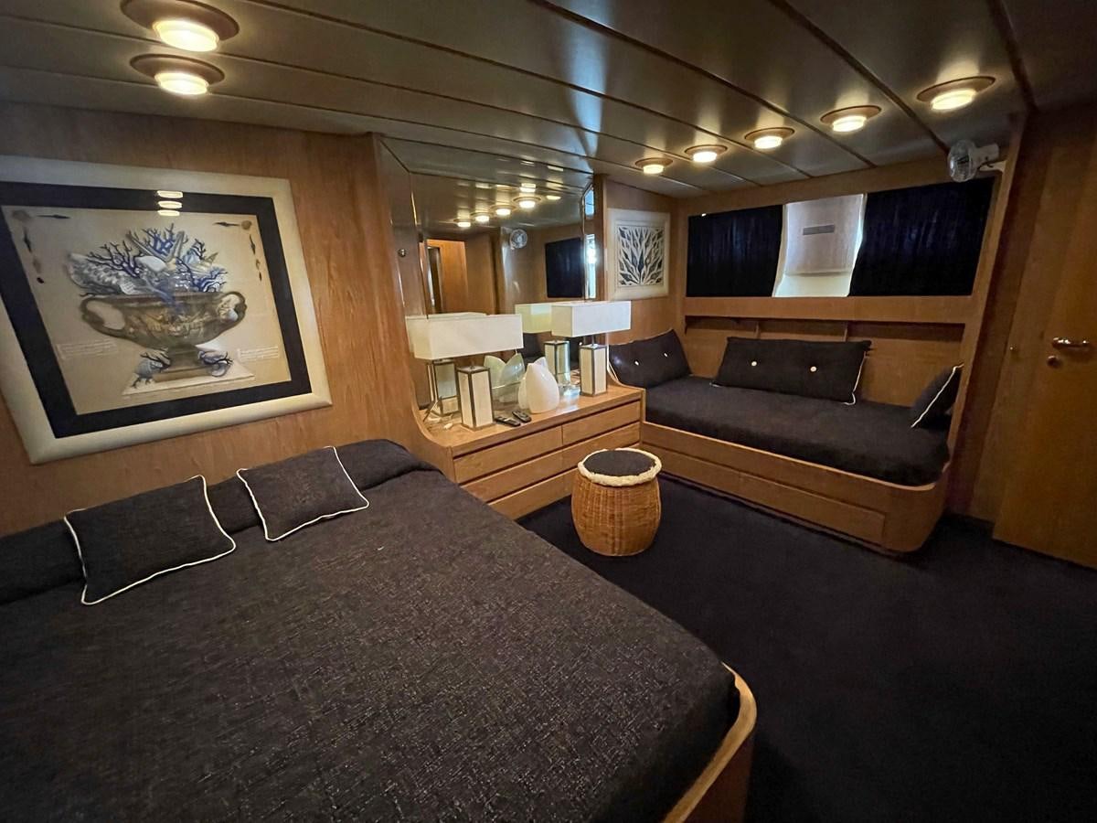 a bedroom with a bed and a couch aboard QUADRIFOGLIO Yacht for Sale