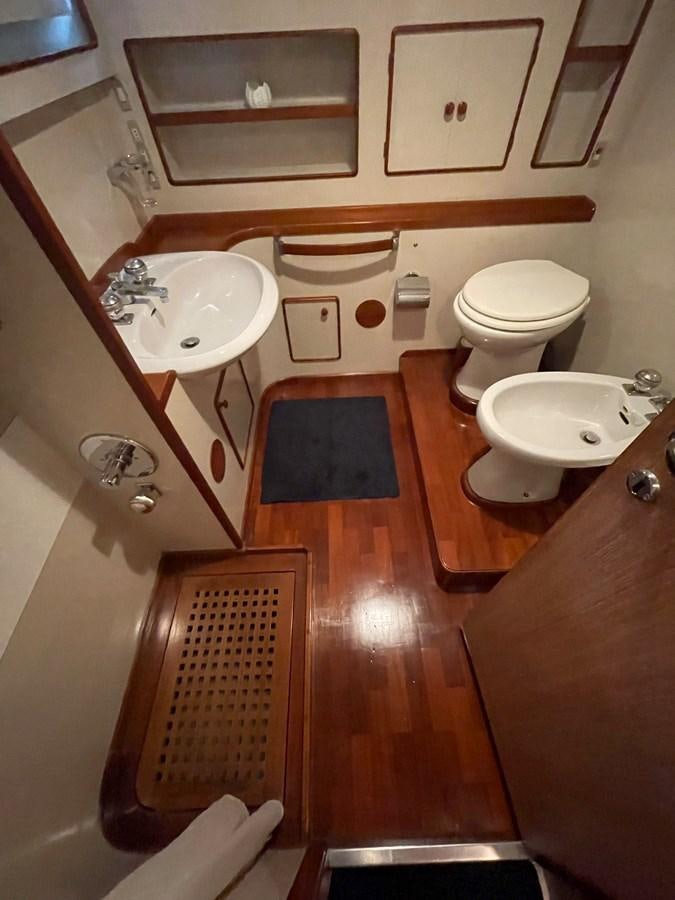 a bathroom with a sink toilet and a bathtub aboard QUADRIFOGLIO Yacht for Sale