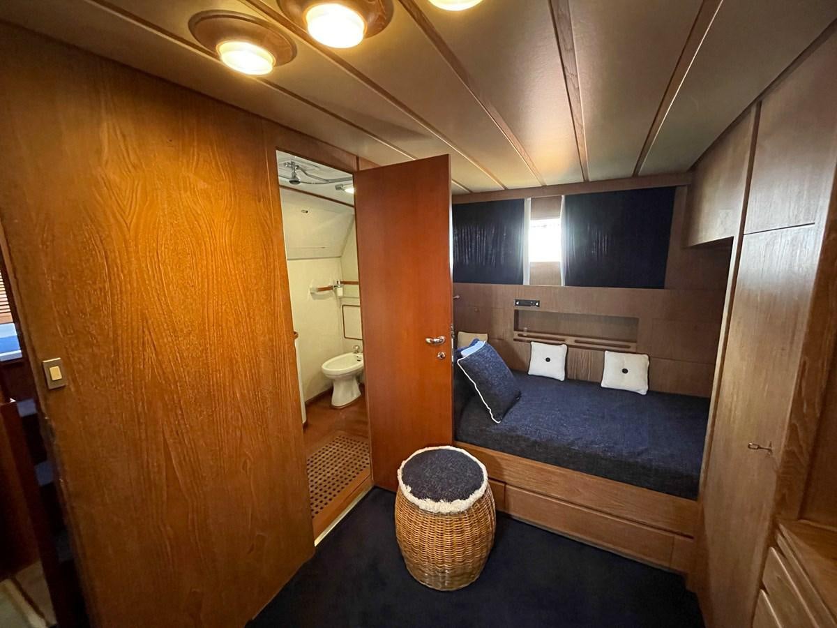 a room with a bed and a mirror aboard QUADRIFOGLIO Yacht for Sale
