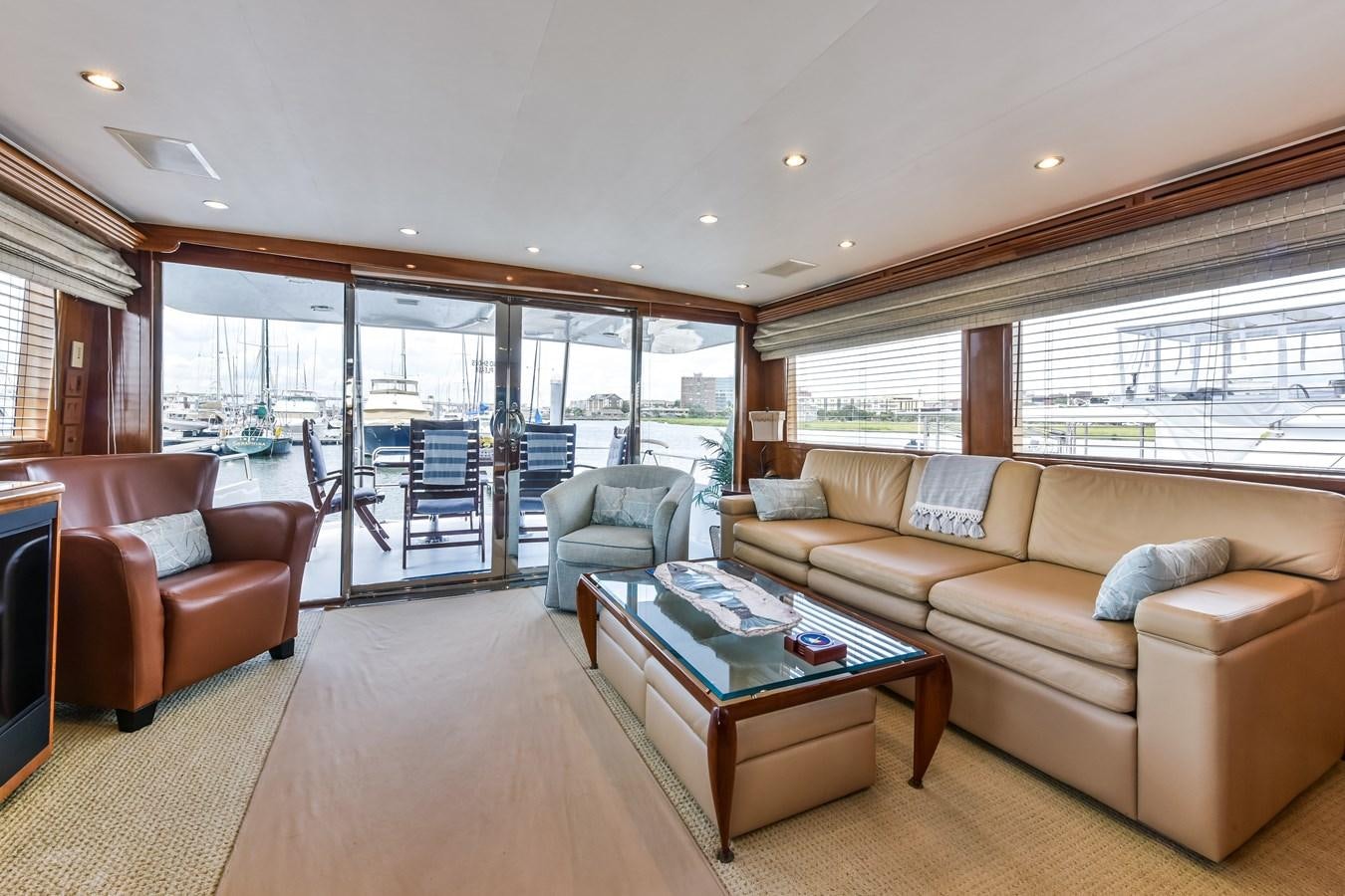 a living room with a large glass window aboard BOOGIE BABE III Yacht for Sale