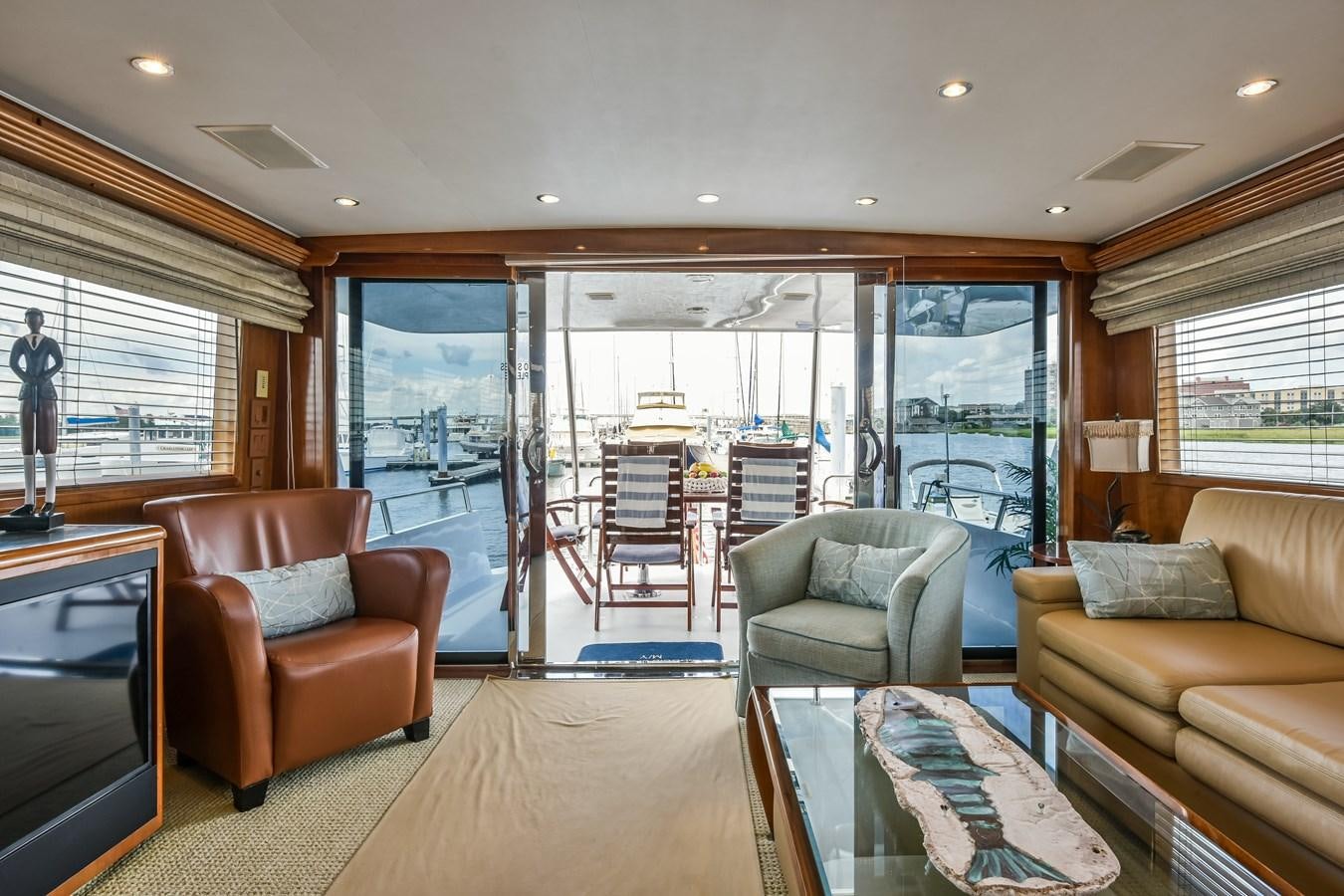 a living room with a glass door aboard BOOGIE BABE III Yacht for Sale