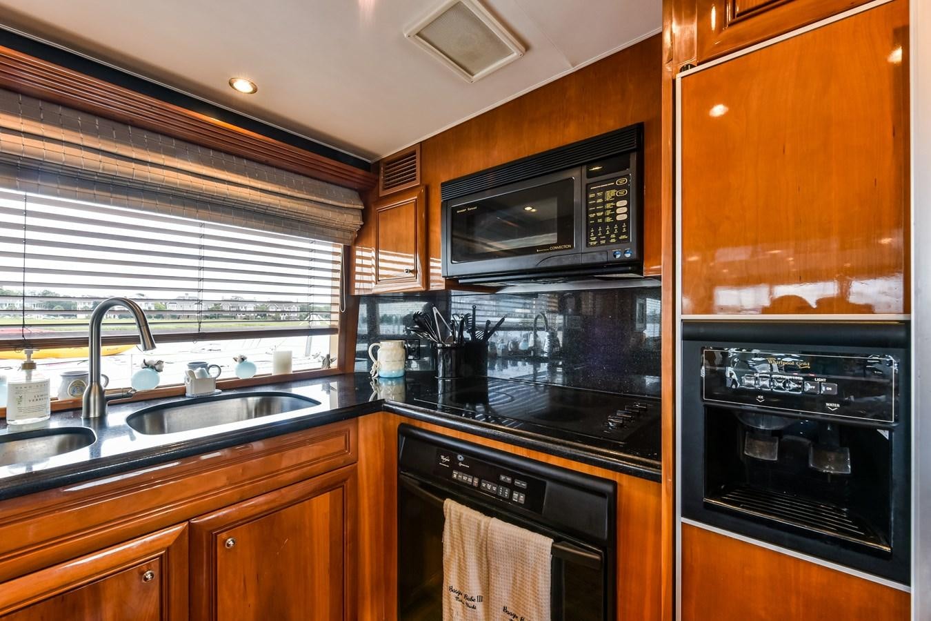a kitchen with wooden cabinets aboard BOOGIE BABE III Yacht for Sale