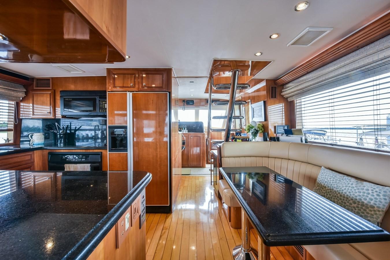 a kitchen with a large island aboard BOOGIE BABE III Yacht for Sale